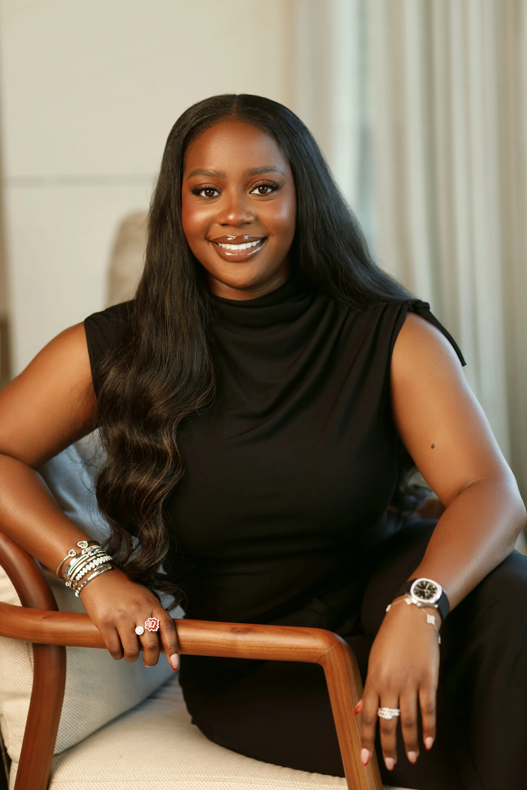 Dynamic portrait of Tochi Wigwe with a vibrant background.